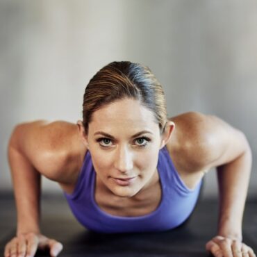 Raising her fitness game Shot of an attractive young woman doing pushups as part of her workout